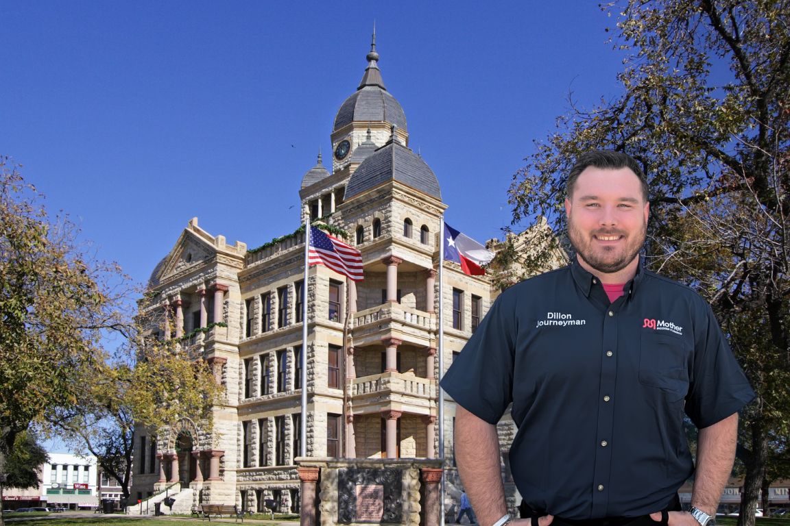 Photo of a uniformed plumber in Denton, TX from Mother Modern Plumbing standing and smiling