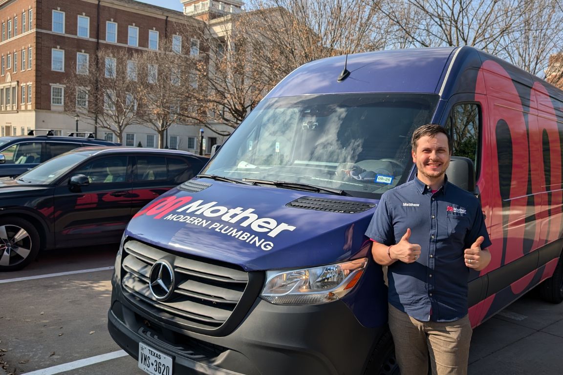 Photo of a uniformed plumber in University Park, TX from Mother Modern Plumbing standing and smiling
