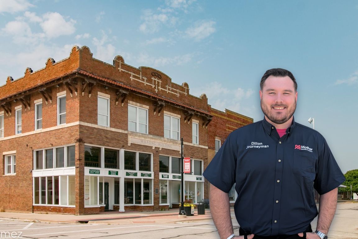 Photo of a uniformed plumber in Sanger, TX from Mother Modern Plumbing standing and smiling