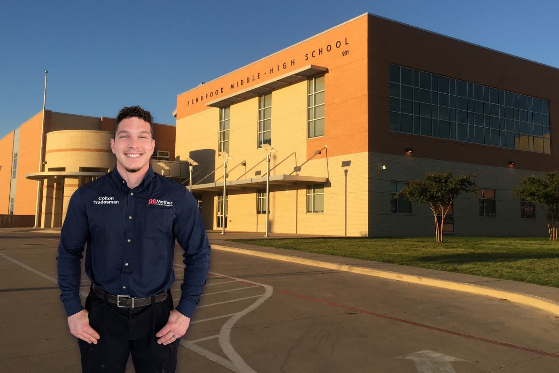 Photo of a uniformed plumber in Benbrook, TX from Mother Modern Plumbing standing and smiling