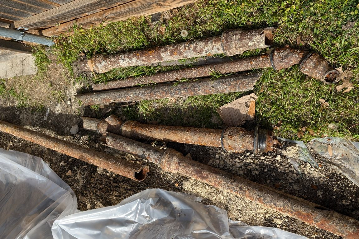 old broken cast iron sewer pipes in dallas, texas backyard
