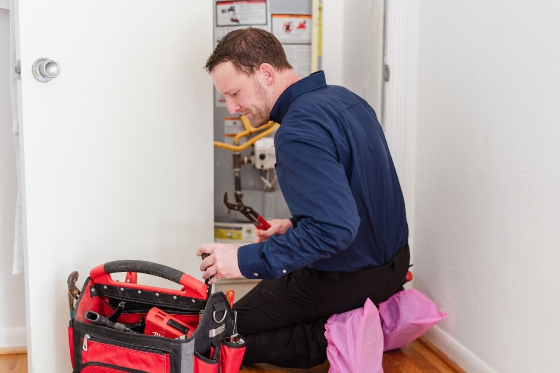A plumber from Mother Modern Plumbing performing Get Your Water Heater Flushed By A Pro in White Rock | Dallas