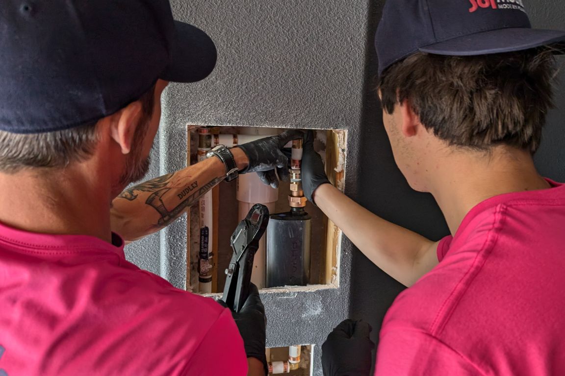 technicians install water eater shut-off valve, smart home plumbing