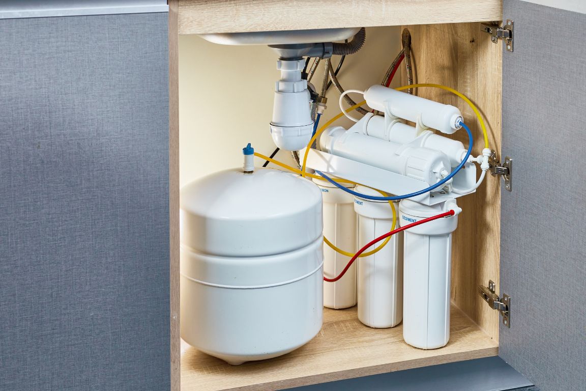 A point-of-use reverse osmosis filter under a smart sink.