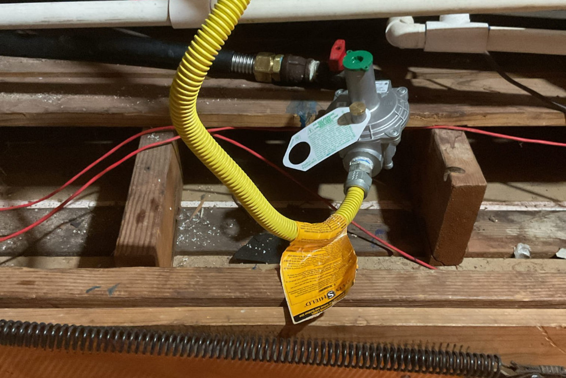 natural gas line and valve hookup in wall behind tankless water heater system, mother modern plumbing