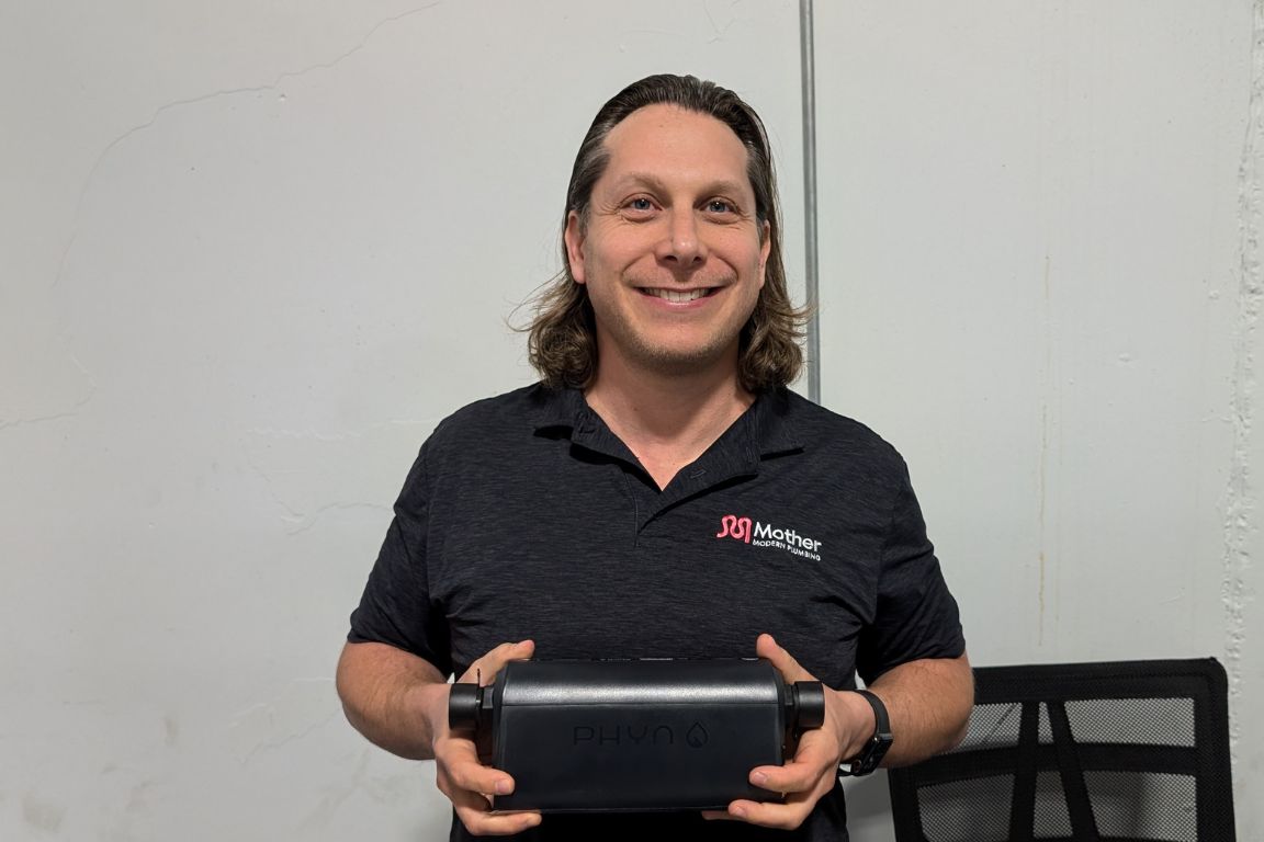 Dustin Marx, founder of Mother Modern Plumbing, with a Phyn Plus 2nd Generation Smart Water Assistant