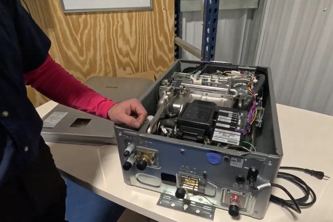 rinnai tankless water heater with cover removed to show internal parts, mother modern plumbing