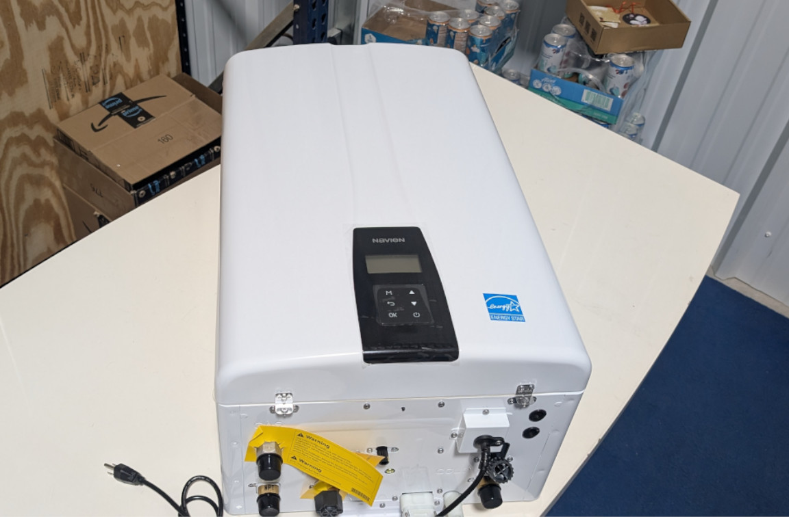 navien npe-240a2 tankless water heater sitting on table for plumber product review