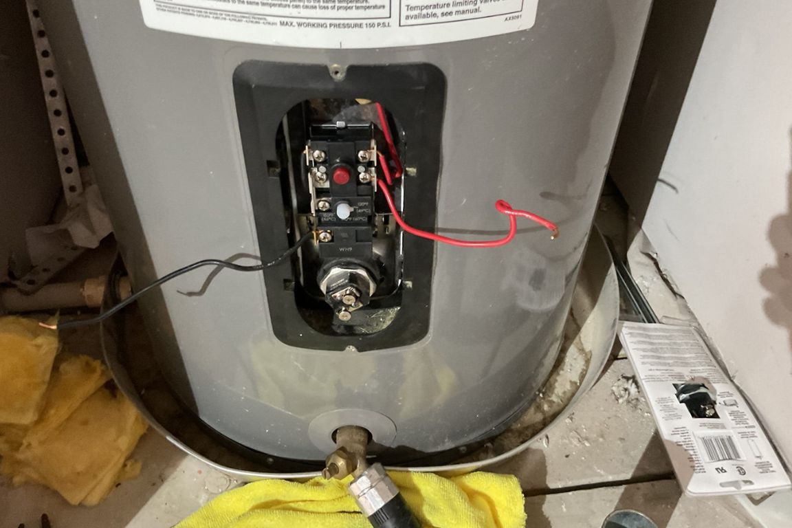 close up of tank leak on conventional water heater in dallas, tx