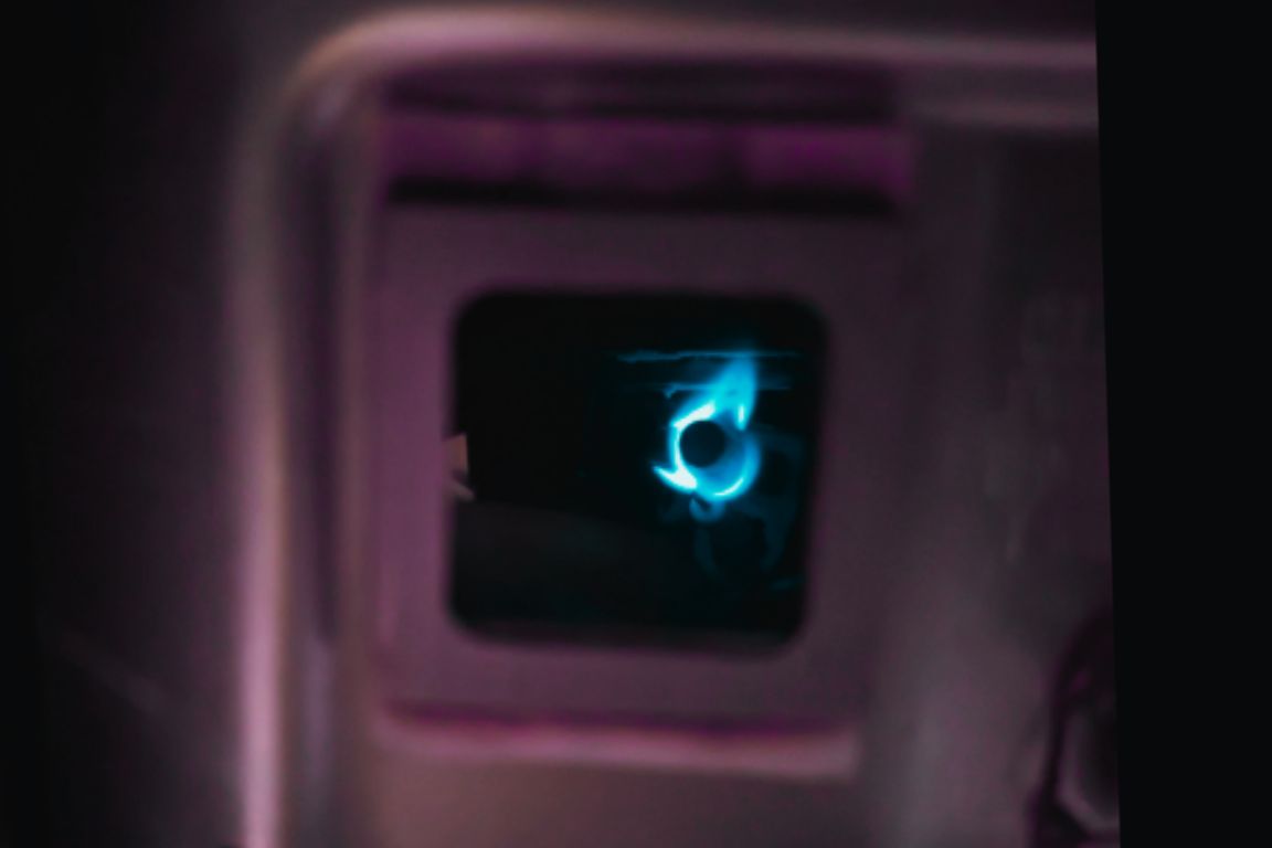 close up of blue flame in gas water heater pilot light assembly