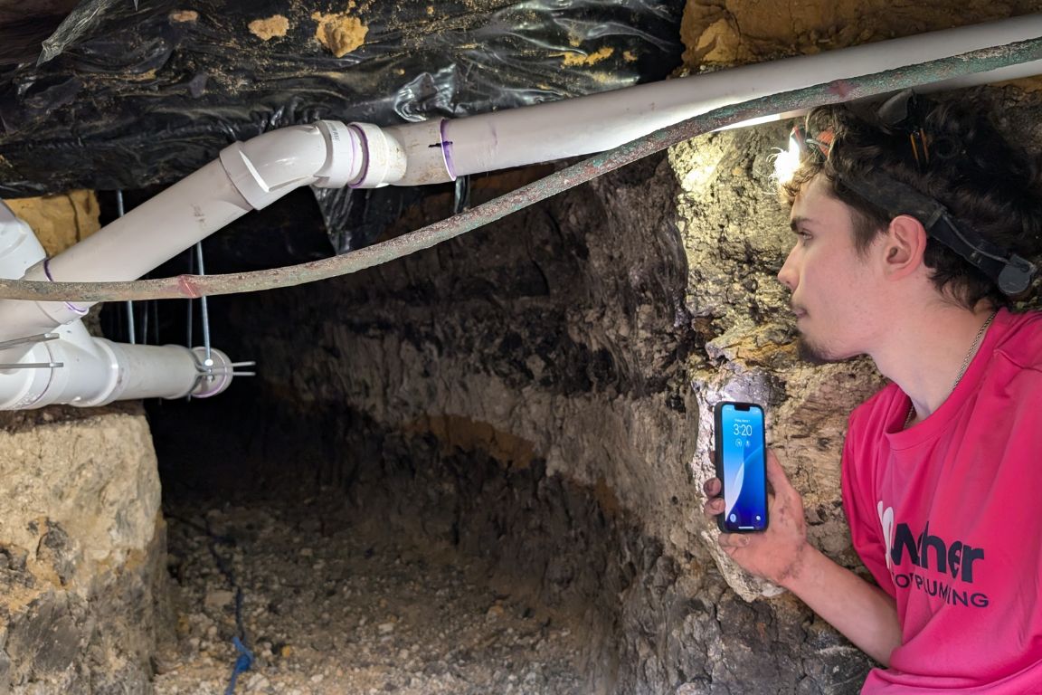 A plumber from Mother Modern Plumbing performing Sewer Line Repair and Replacement in Dallas
