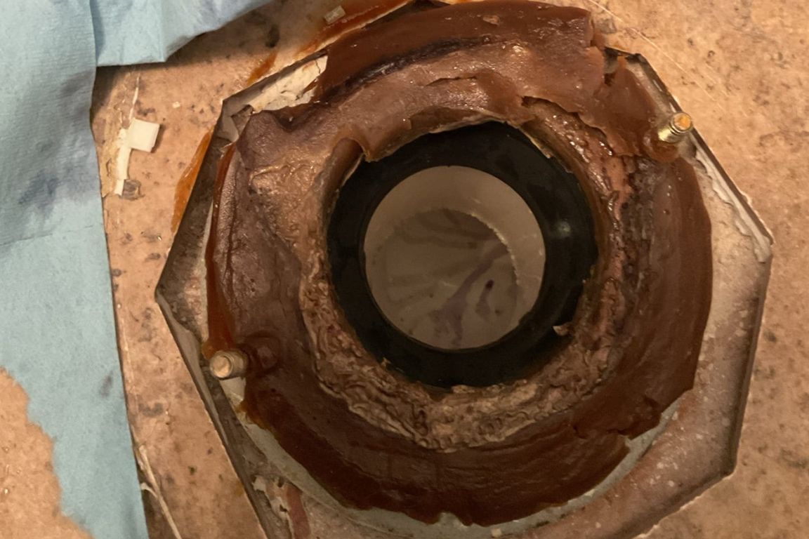 photo of failing wax seal on floor under toilet, mother modern plumbing