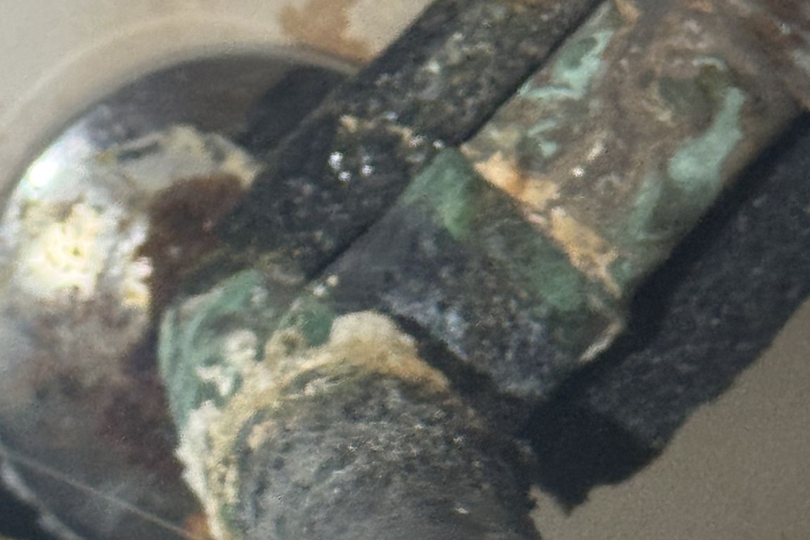 copper water pipe in dallas, tx bathroom showing signs of teal, crusty electrolysis