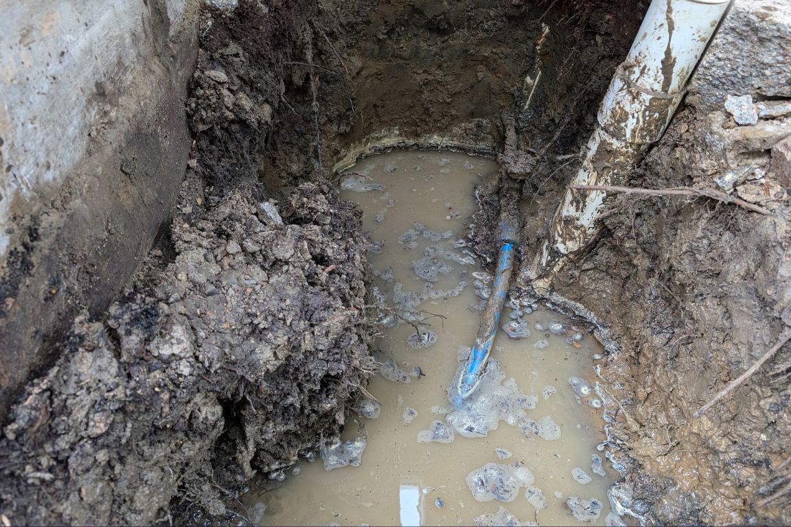 excavated major slab leak in pvc pipe near rowlett, tx foundation creating pool of water in clay soil