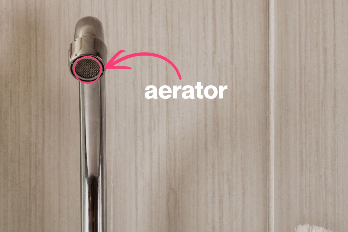 kitchen sink faucet with circle and arrow pointing on aerator screen on spout