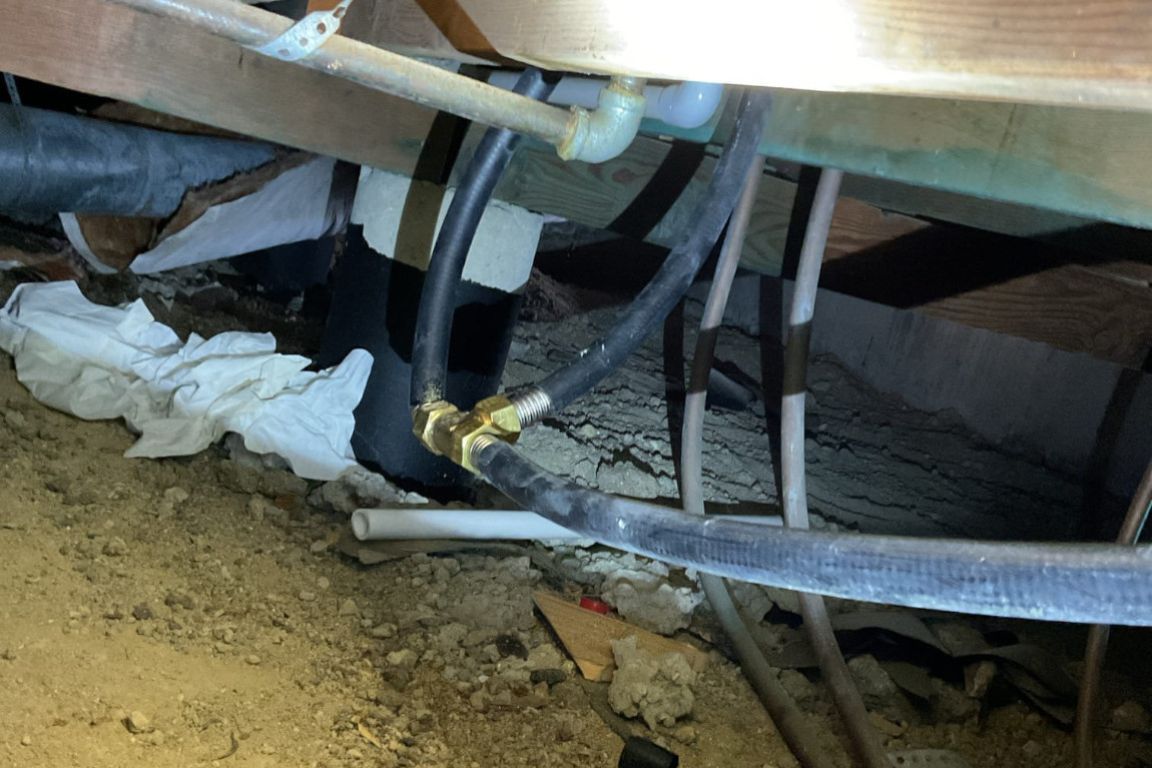 buried gas line under bathroom subfloor in dallas, texas, showing signs of necessary repairs