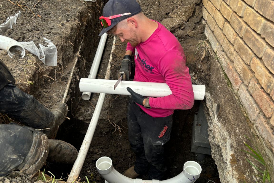 main sewer line replacement along side of frisco, tx brick home, mother modern plumbing