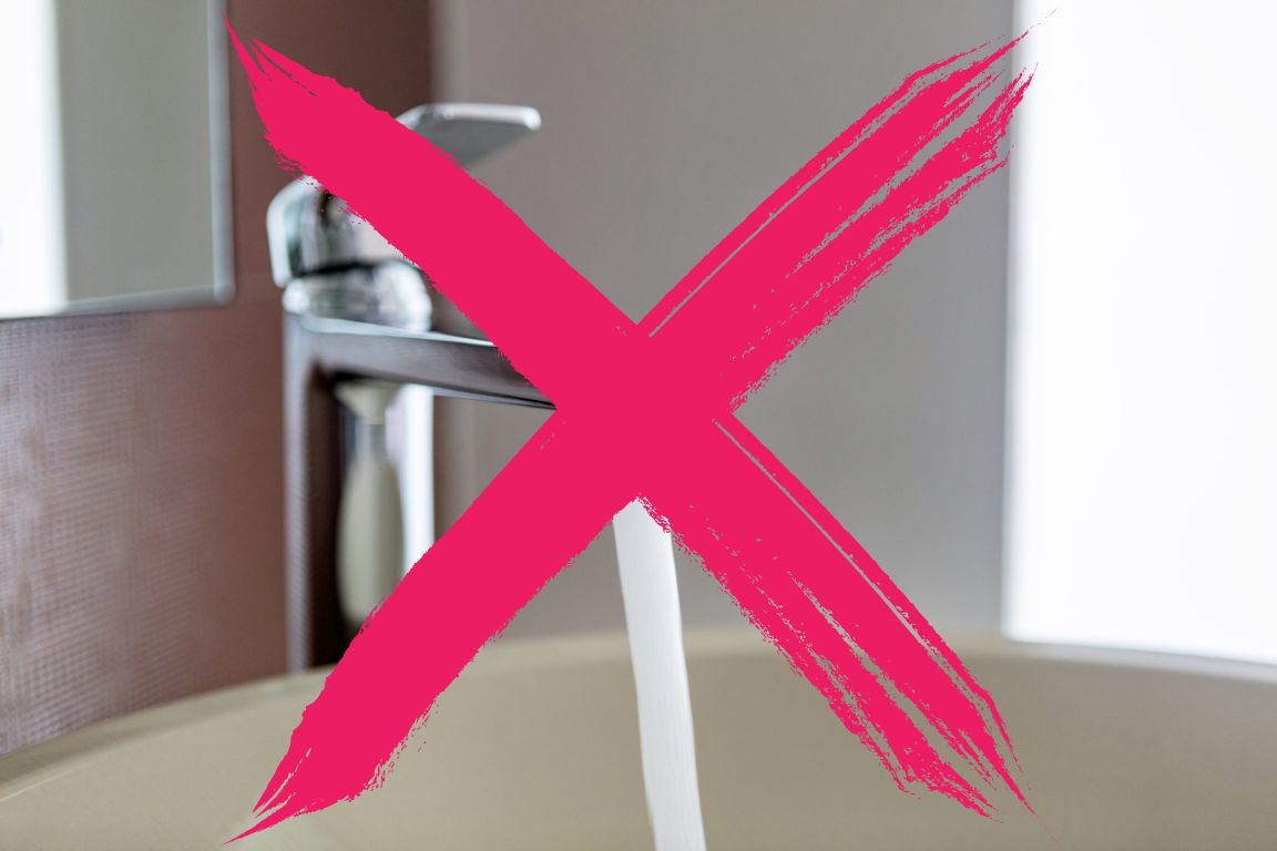 pink x over sink faucet to indicate never to run water during a home sewer backup