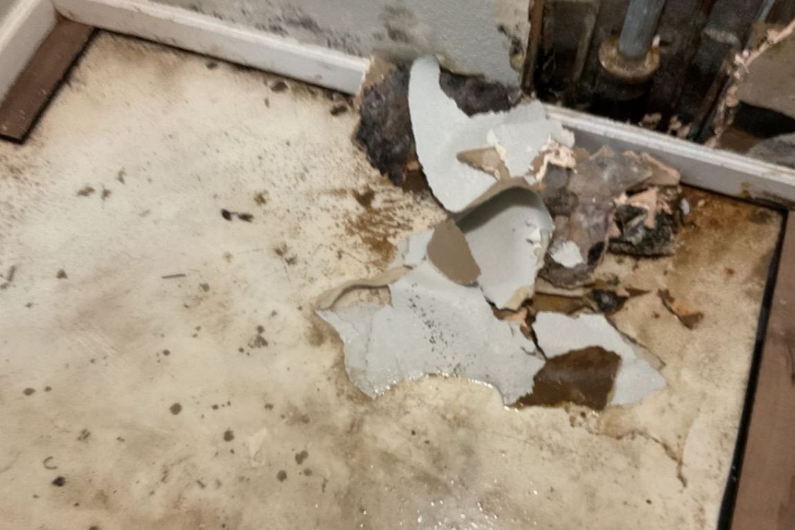 damaged master bathroom wall and tile from sewage backup emergency in preston hollow home, repaired by mother modern plumbing