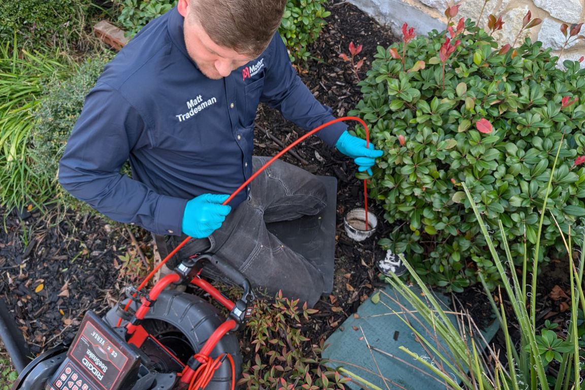 licensed plumber inserts sewer camera inspection equipment into exterior cleanout in fort worth, tx home, mother modern plumbing