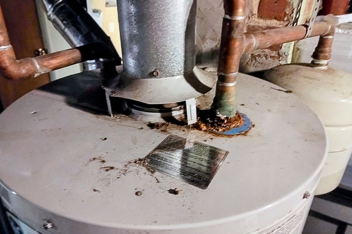 close up of cold water inlet valve on water heater tank with blue ring