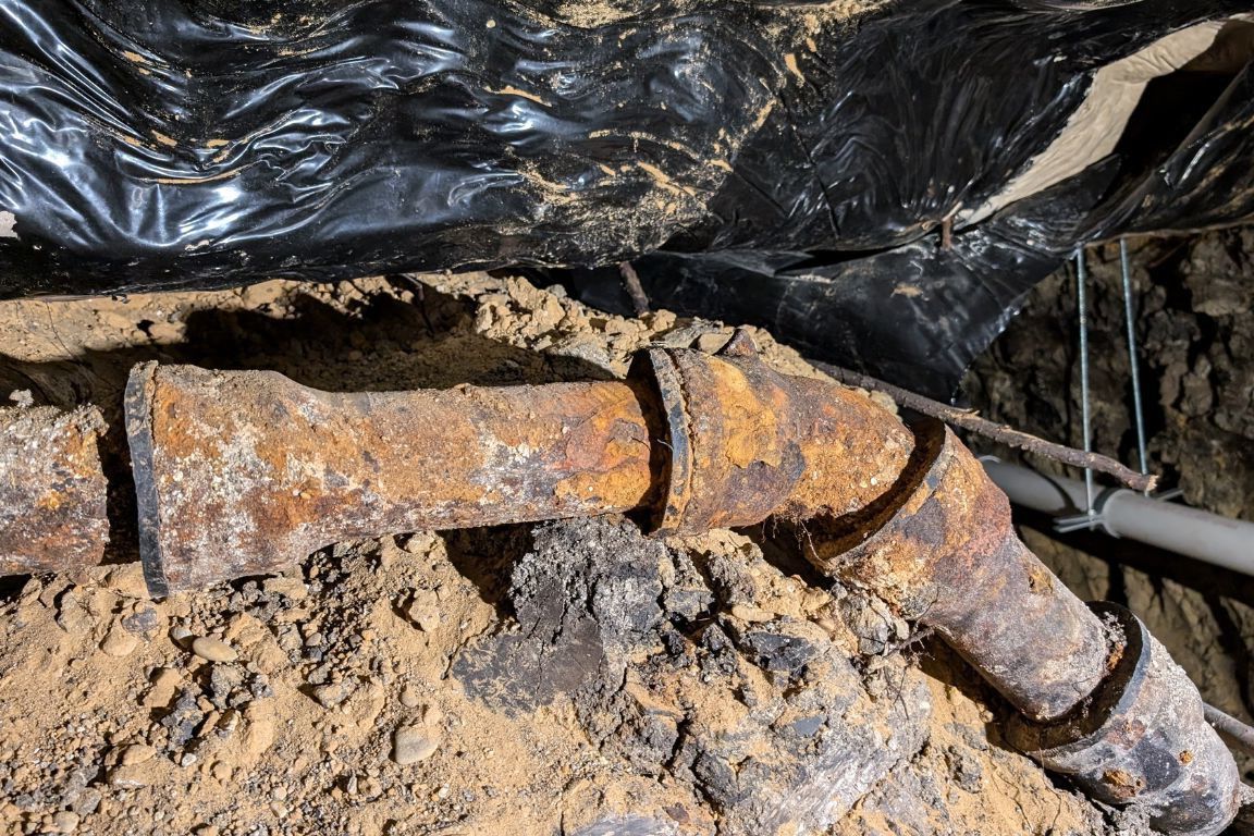 damaged section of cast iron sewer pipe removed from fort worth tx backyard during replacement service, mother modern plumbing