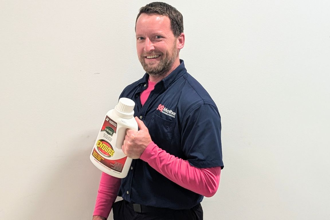 master plumber steven smith holds bottle of endure bacterial drain cleaner for ongoing maintenance against drain gnats
