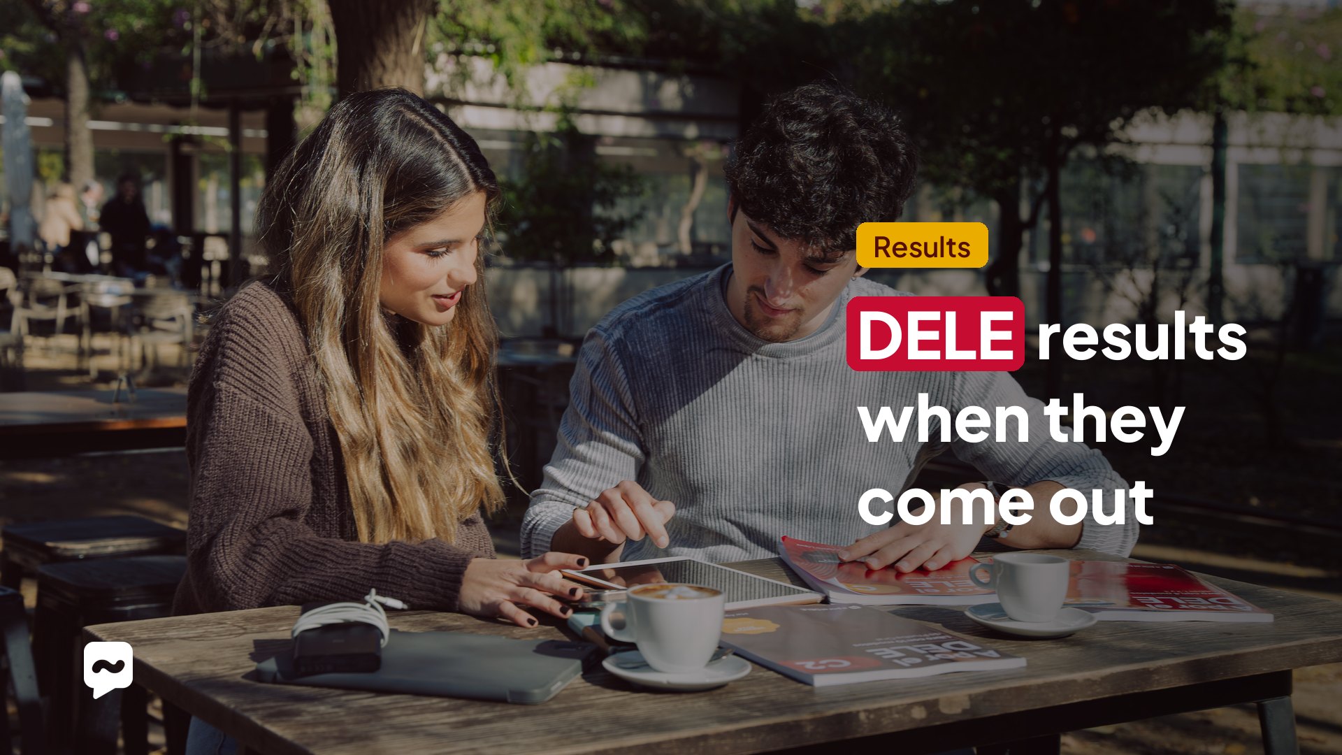 DELE results: when they come out. Two students checking their grades on a tablet