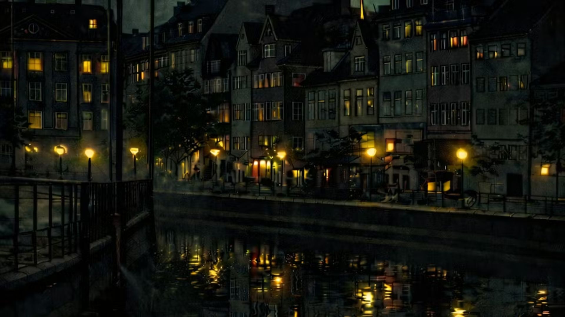 Huse og en kanal i mørket med gadelys