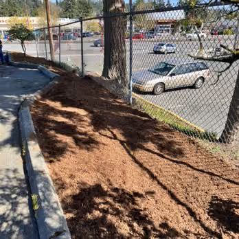 Fresh mulch bed installed by Grizzly along a property line