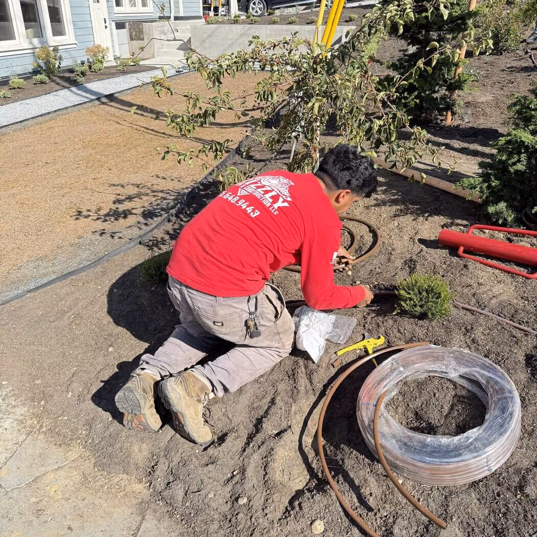 Grizzly crew member connecting drip irrigation line