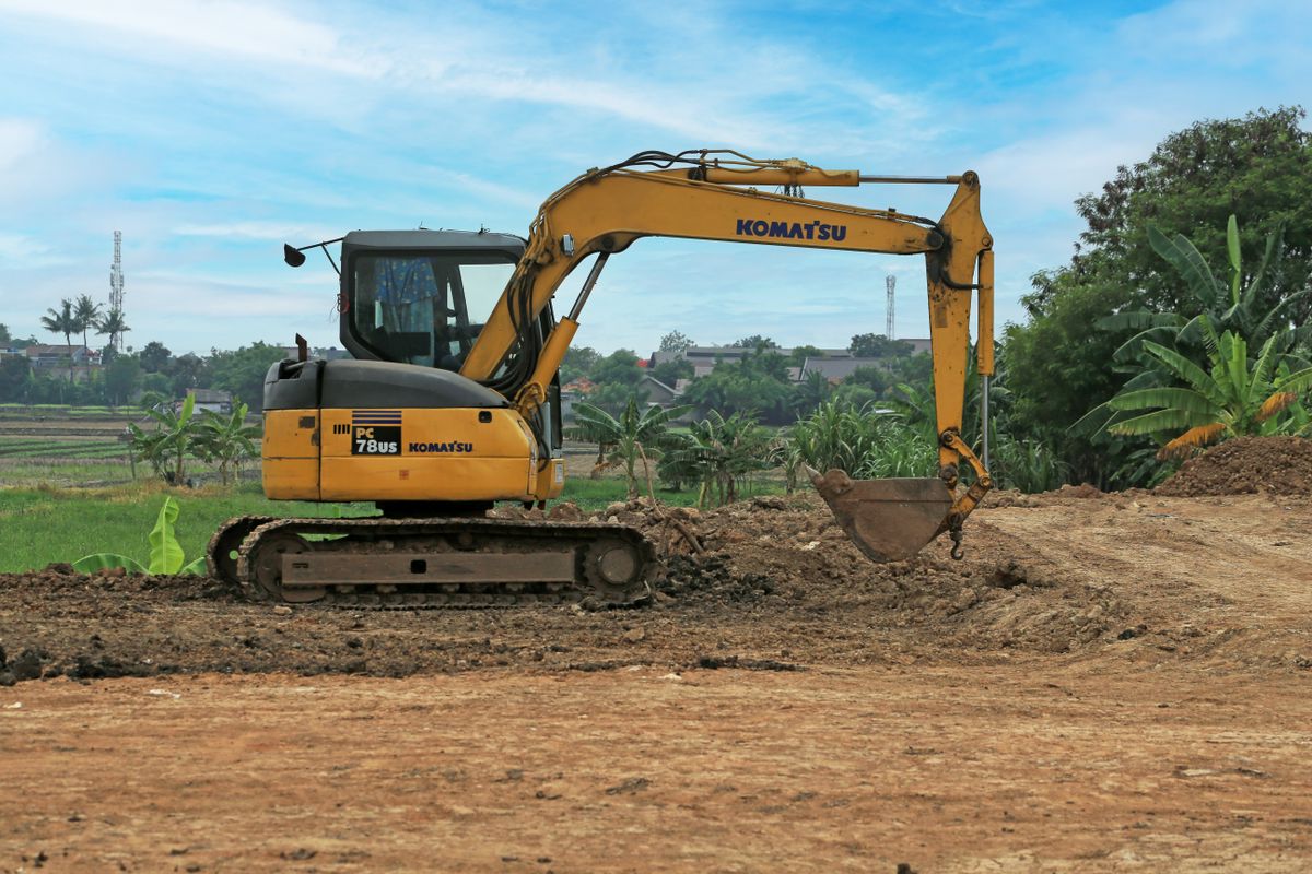 Excavator digging on a site prep job