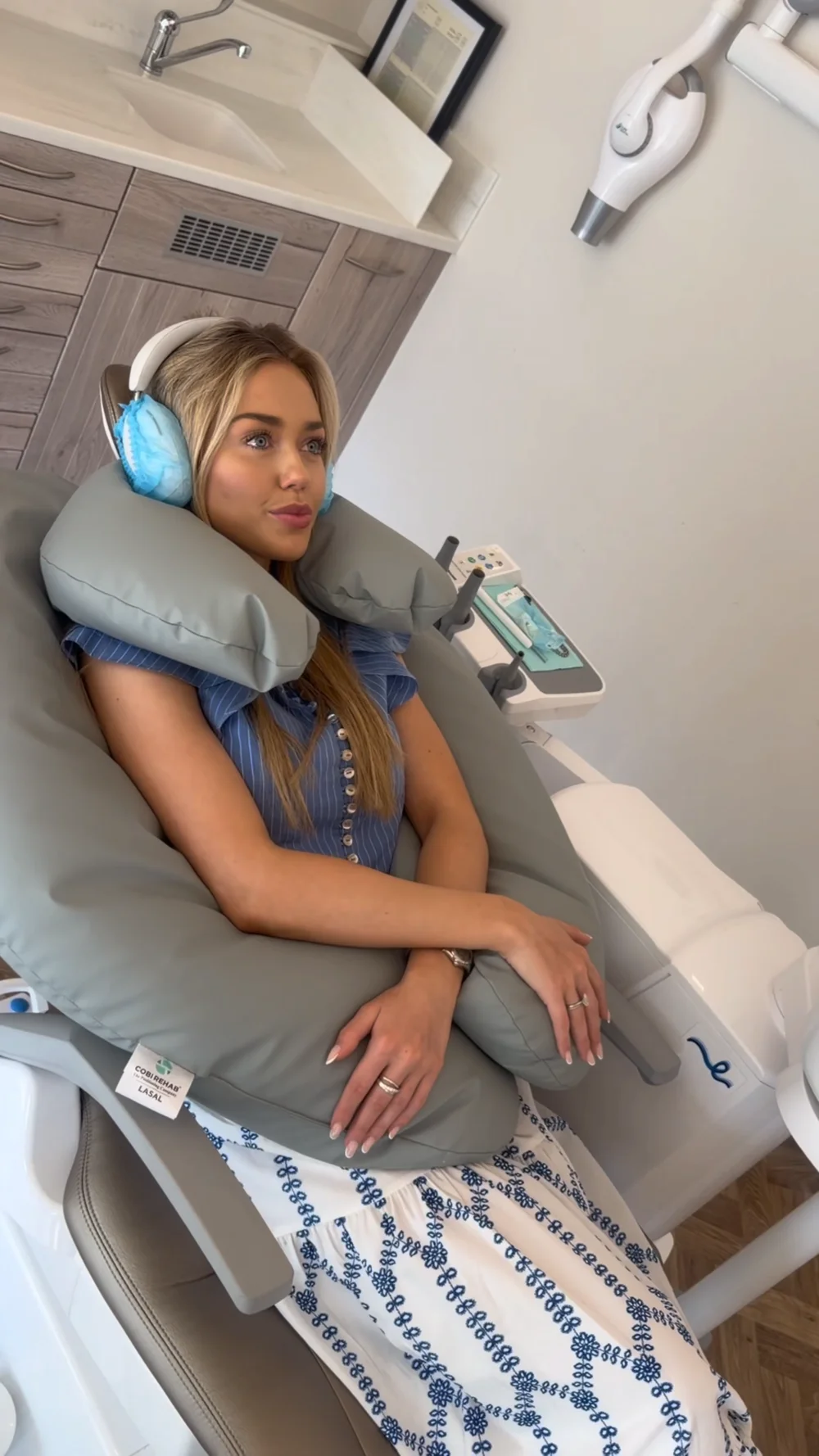 Patient relaxing with Lasal dental cushions and covered headphones at The Dental Barns.