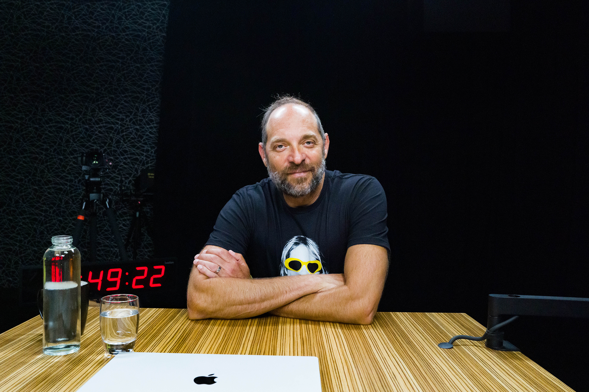 Adam Skolnick in a dark Studio with laptop