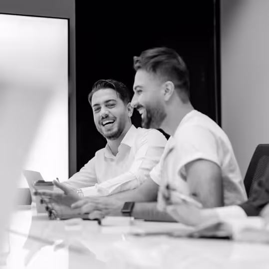 a couple of men sitting at a table