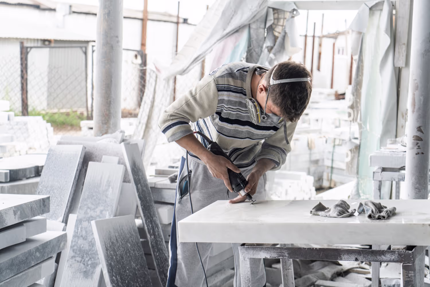 A man working on a piece of granite.
