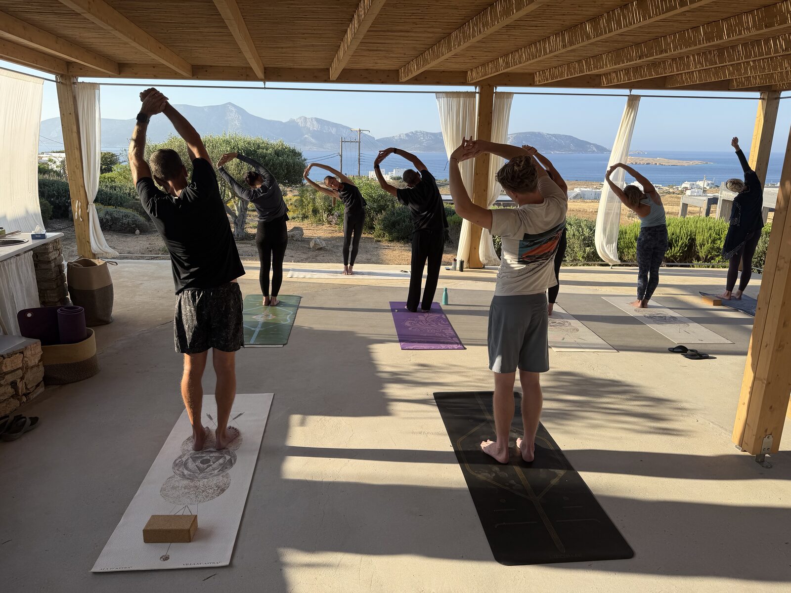 The shaded yoga pergola above the water