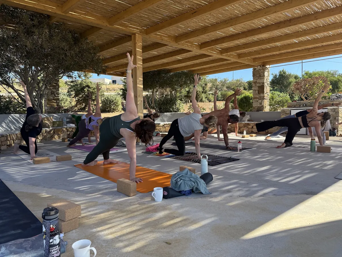 Morning practice under the pergola, mats laid out toward the sea
