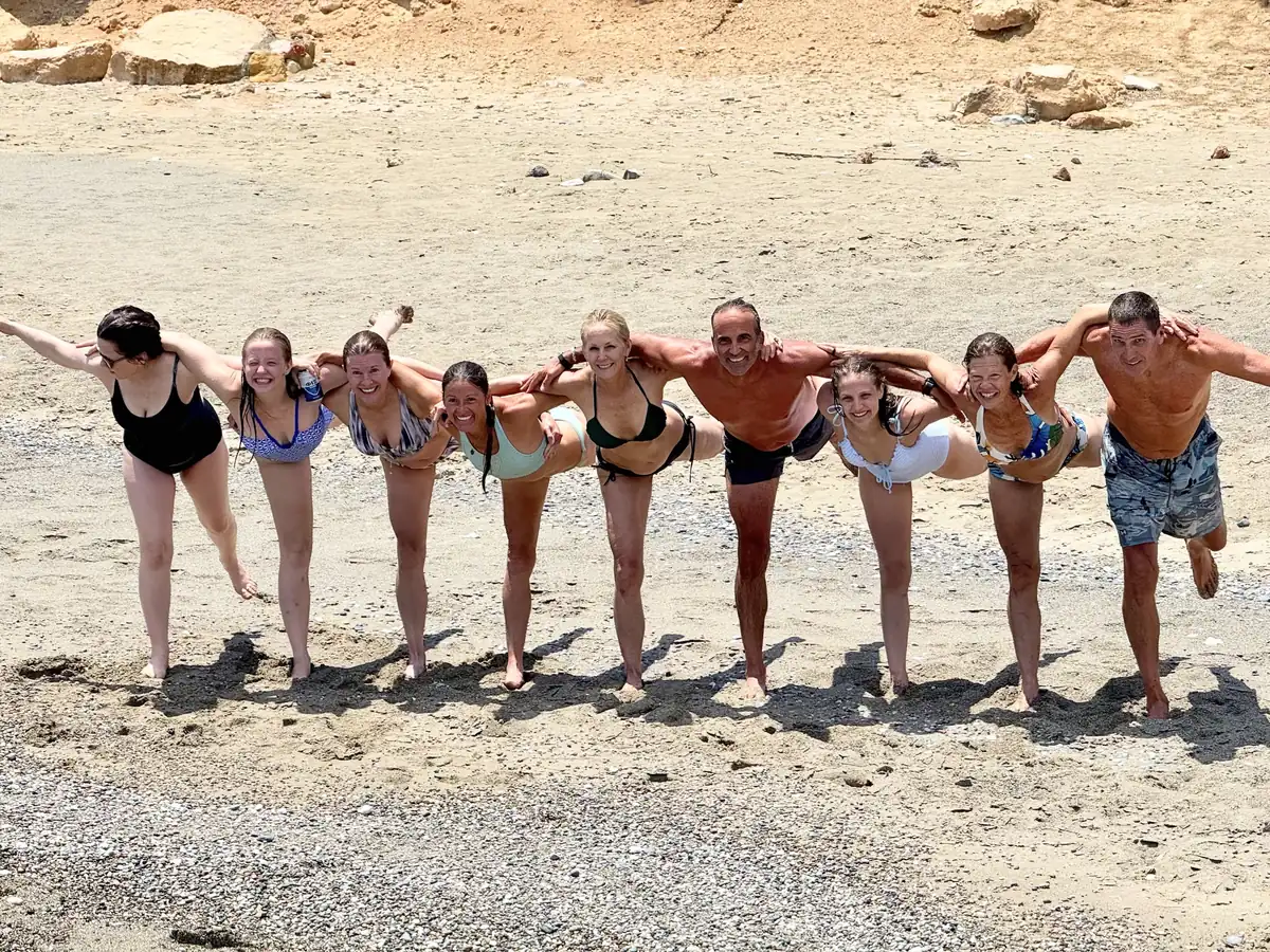 Guests lined up arm in arm on the sand