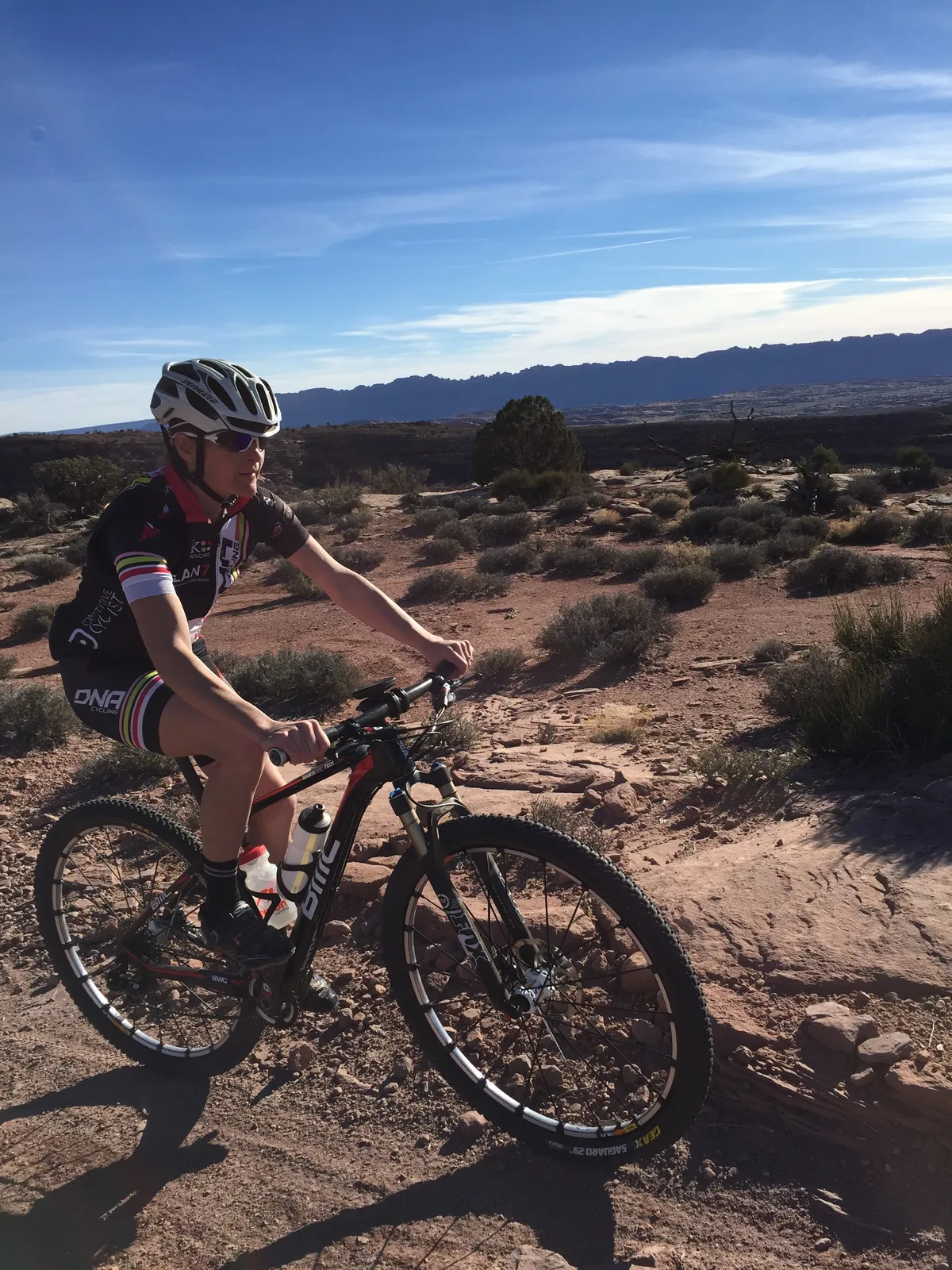 Rachel Cieslewicz riding across open desert singletrack