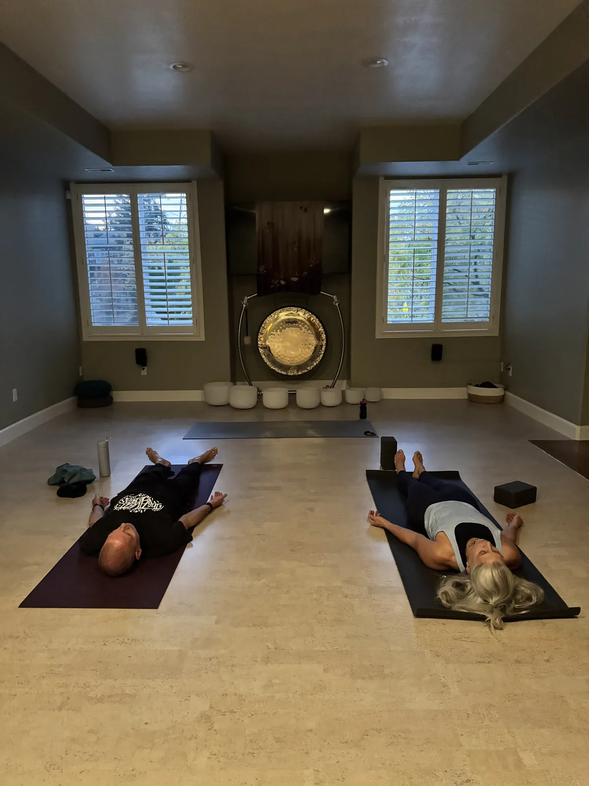 Two students resting in savasana at the YogaSoul shala