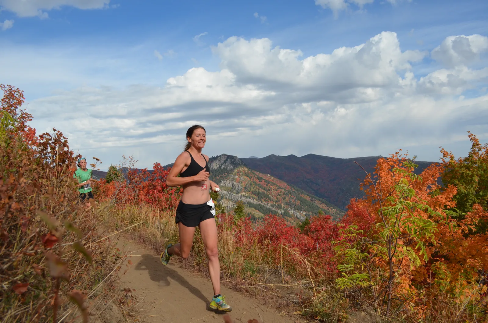 Rachel Cieslewicz trail running through autumn maples above Salt Lake City