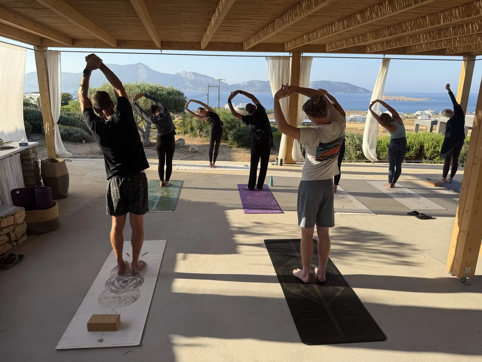 The shaded yoga pergola above the water