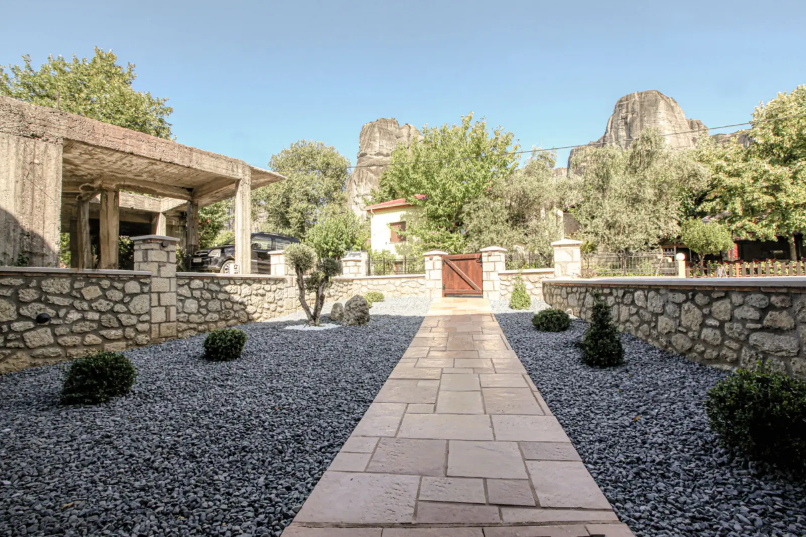 The courtyard path at the suites, with the Meteora rocks rising behind