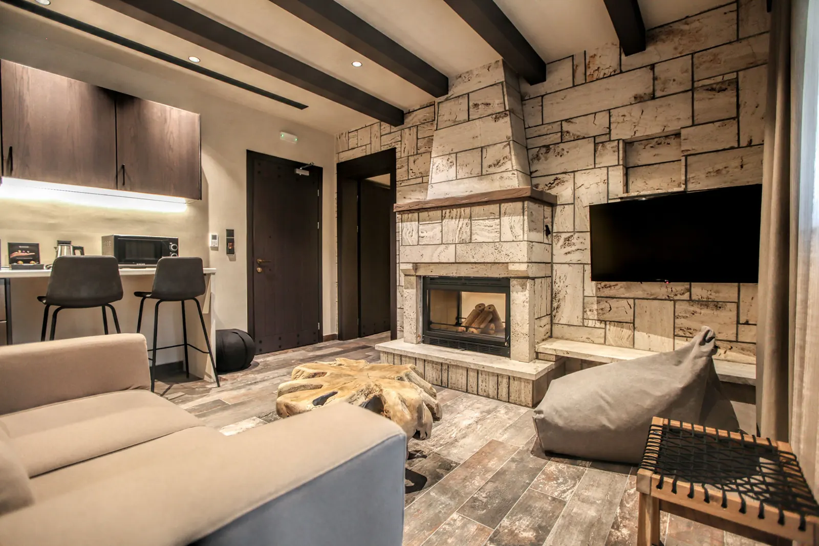A suite sitting area with a stone fireplace
