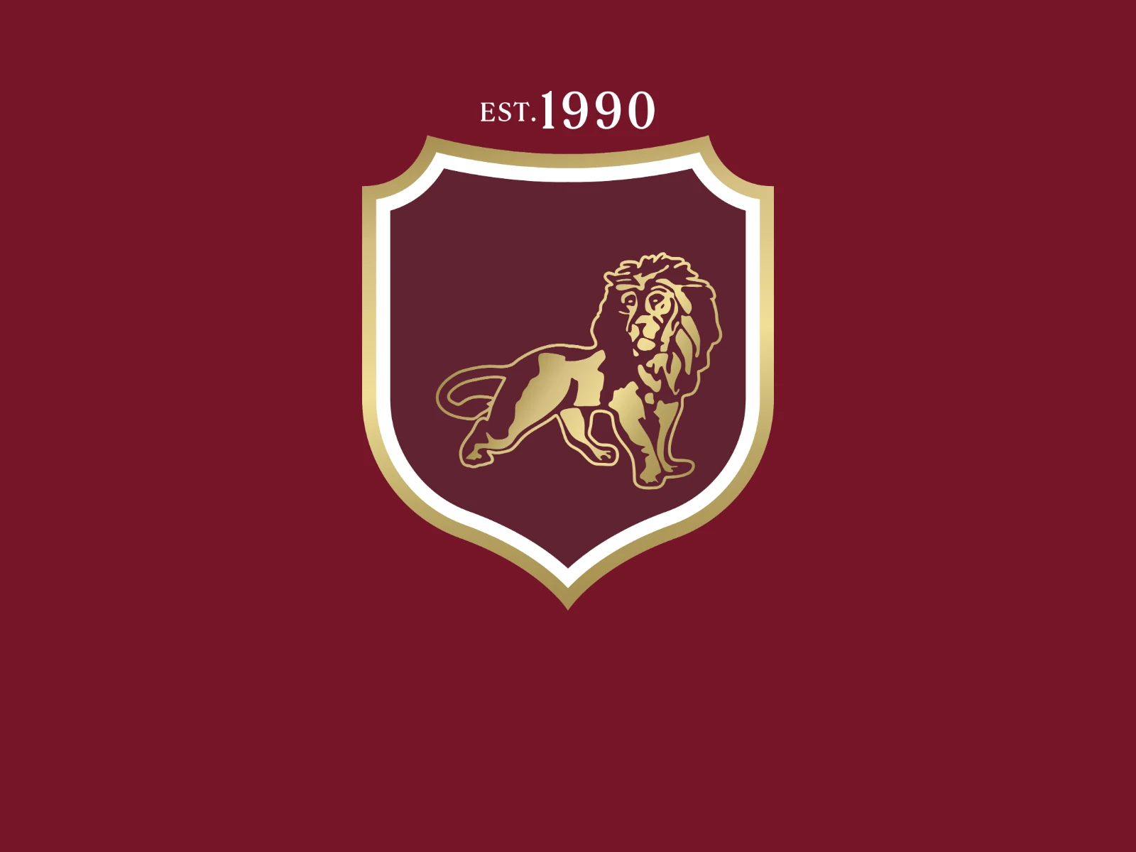 The AIS Grup crest on burgundy: a gold-rimmed shield with a gold lion, under 'est. 1990'.