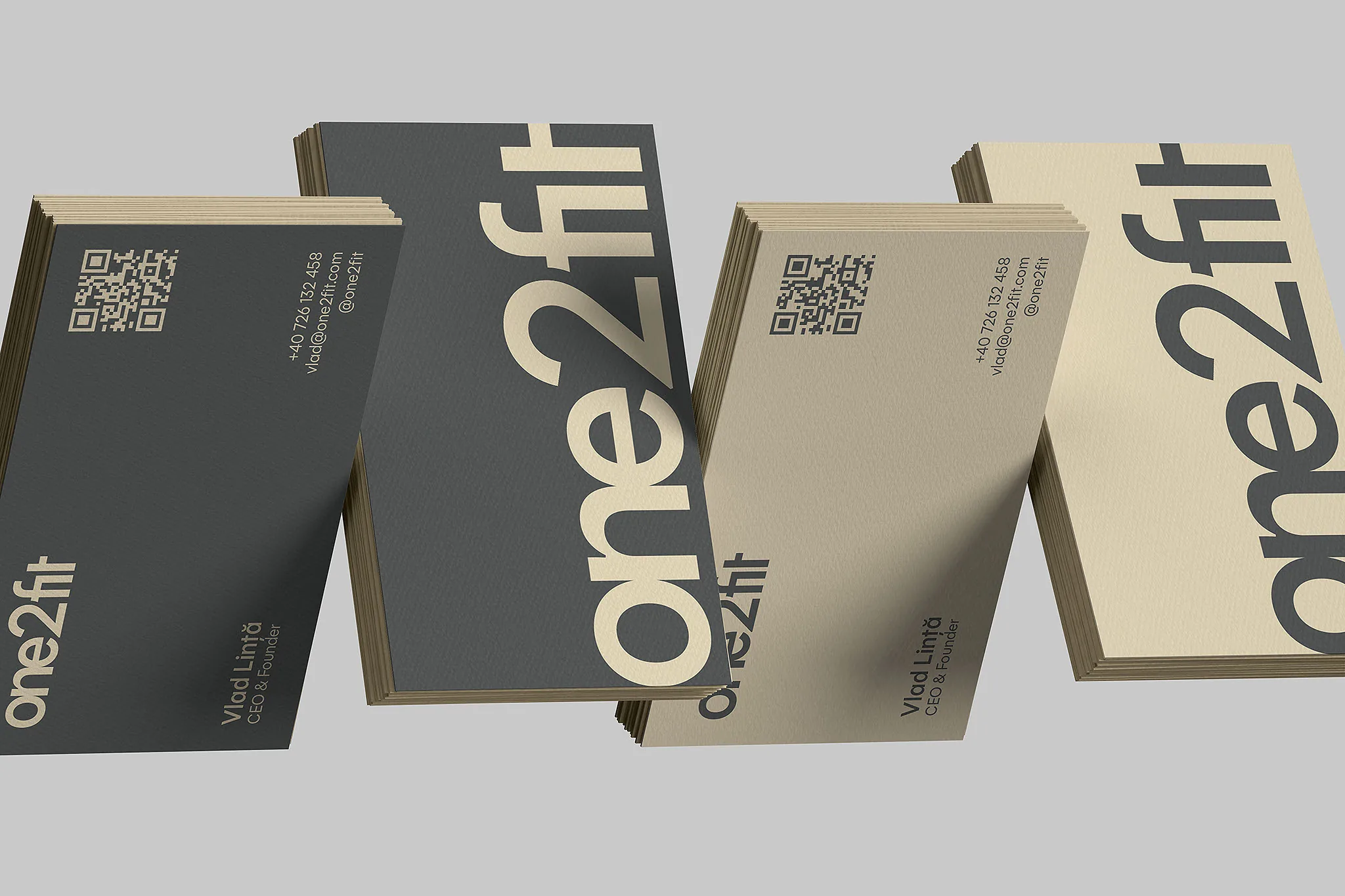 one2fit business cards in charcoal and beige: the wordmark running down one side, the Moșilor address and a QR code on the other.