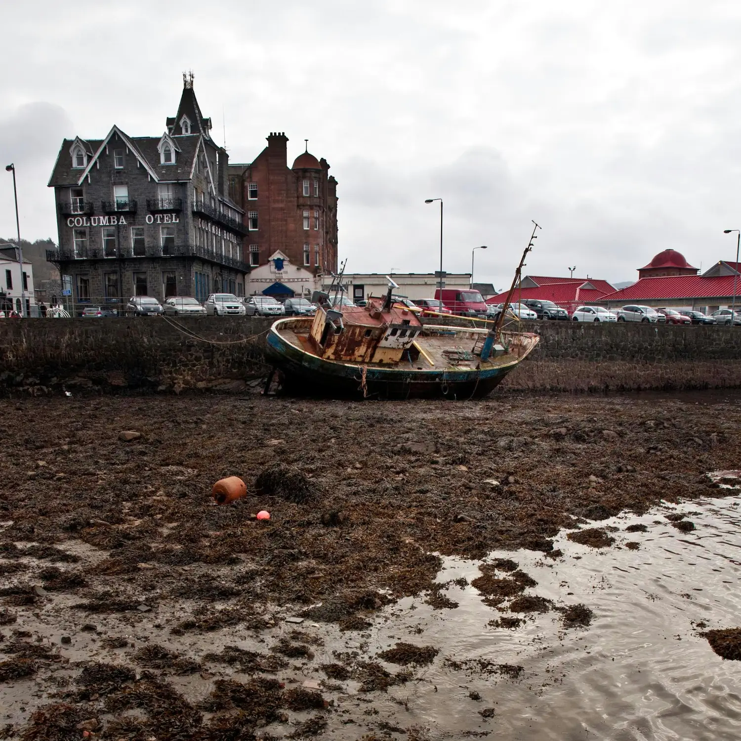 Historic harbour buildings along the shoreline in Oban