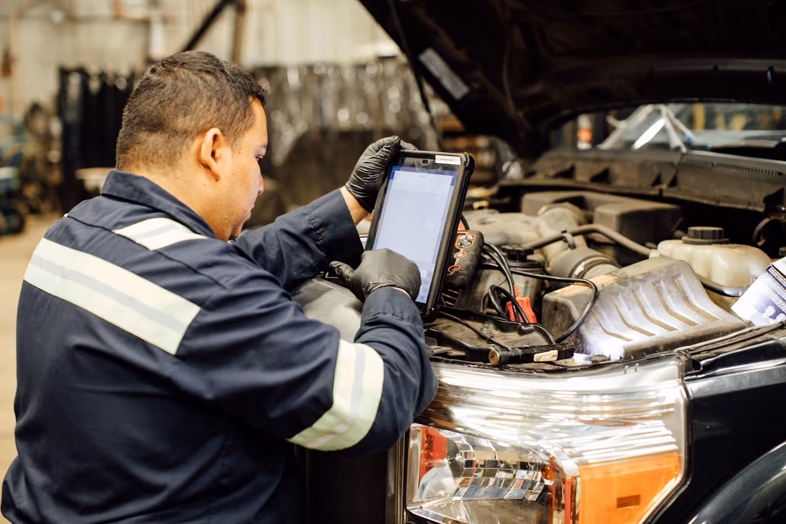 A fleet maintenance technician using a tablet