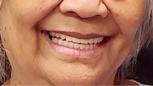 A close up of a woman's face smiling.